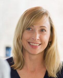 Headshot of Karen Gebhardt, wearing a navy top and looking to the left.
