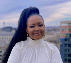 Headshot of Nancy Khasungu Makale, wearing a white, high-collared top.