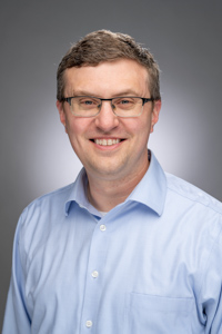 Headshot of a person (Derek Bruff) smiling at the camera