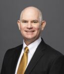 A person (Tom Cavanagh) smiling