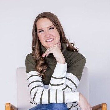 A person (Melissa Jimenez) sitting in a chair and smiling
